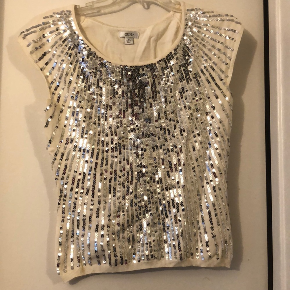 cream sparkly shirt